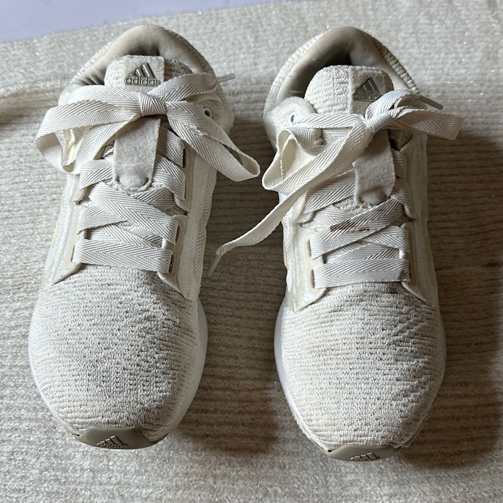 Nice adidas women’s gym shoes in white with iridescent  stripes on both sides.